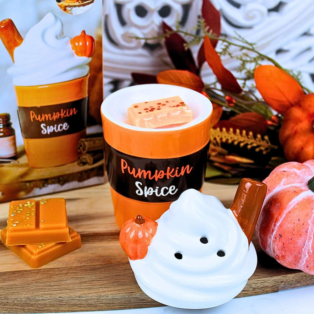 Top view of Pumpkin Spice Latte wax melt burner with autumn wax melt and swirl-style lid beside it