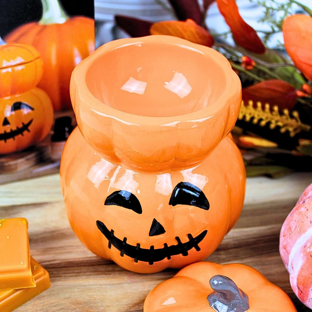 XL ceramic pumpkin wax melt burner with lid on, styled with pumpkins and autumn decorations for Halloween ambience