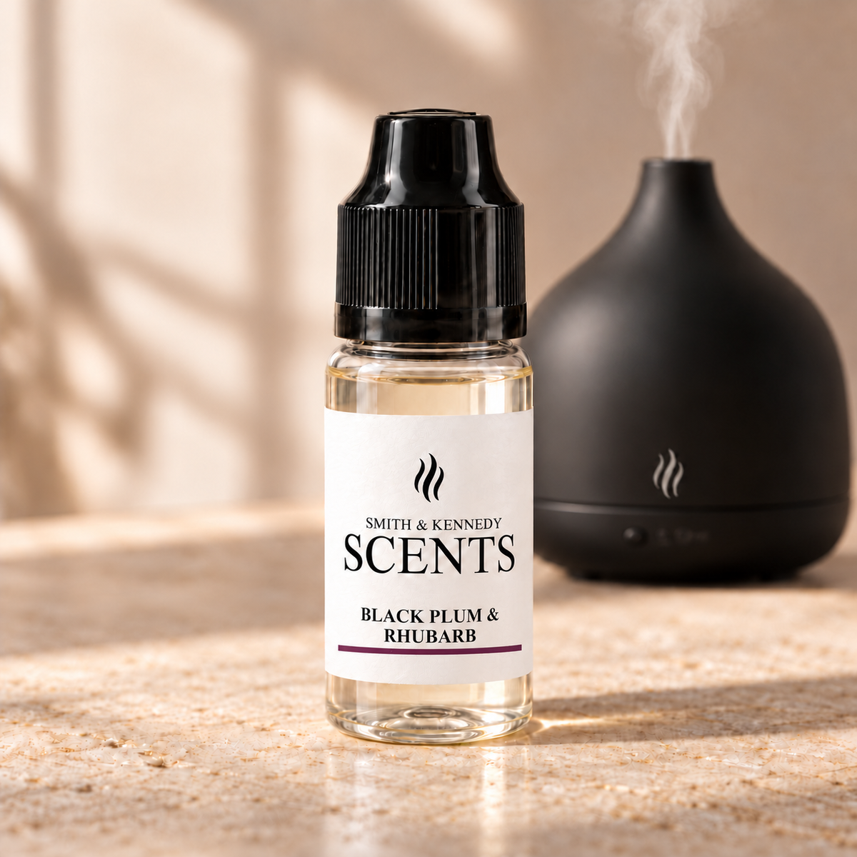Black Plum & Rhubarb 10ml aroma diffuser oil in a clear plastic bottle with black cap, beside an electric diffuser