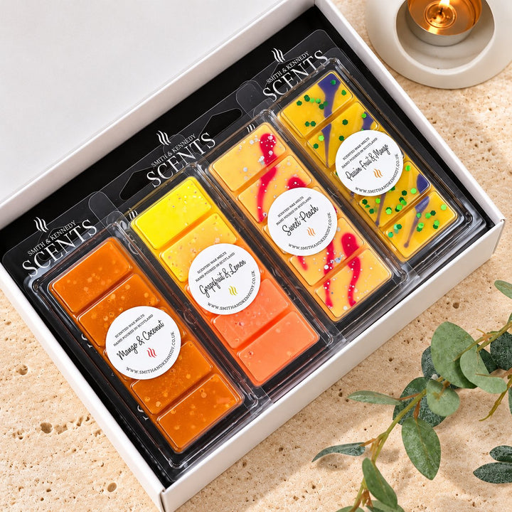 Fruit Wax Melt Collection by Smith &amp; Kennedy Scents: Mango &amp; Coconut, Grapefruit &amp; Lemon, Sweet Peach and Passion Fruit &amp; Mango snap bars in a white gift box.