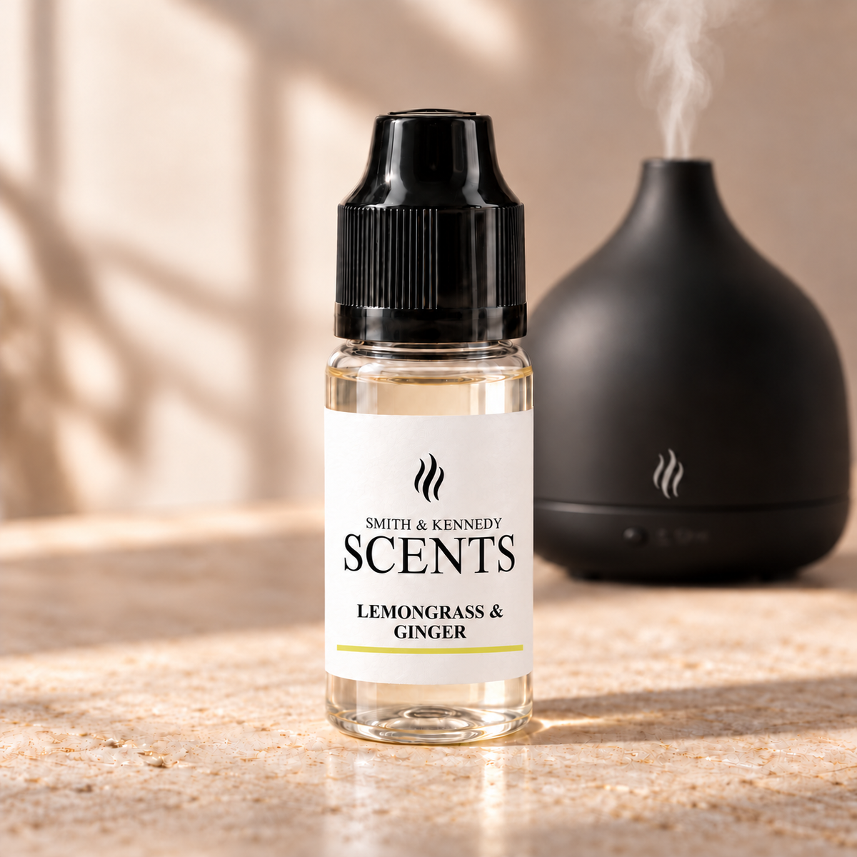 Lemongrass & Ginger 10ml aroma diffuser oil in a clear plastic bottle with black cap, beside an electric diffuser