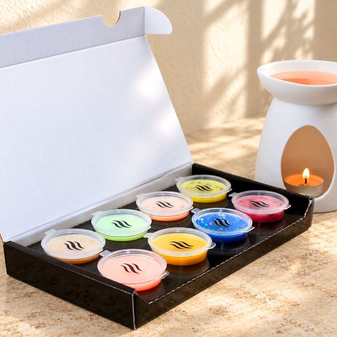 Eight colourful wax melt pods in an open black Smith &amp; Kennedy Scents discovery box
